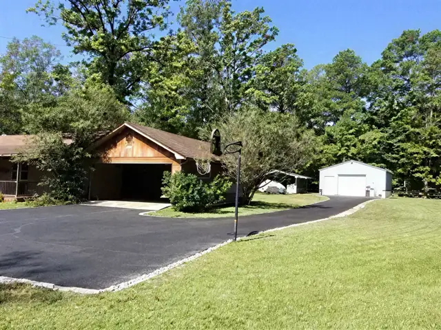 Paved driveway and turnaround in front of a ranch house