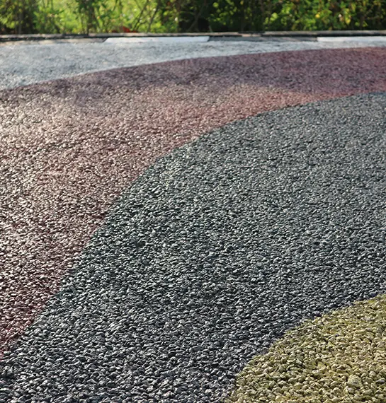 Curved chip-and-seal drive in gray and brown pebble